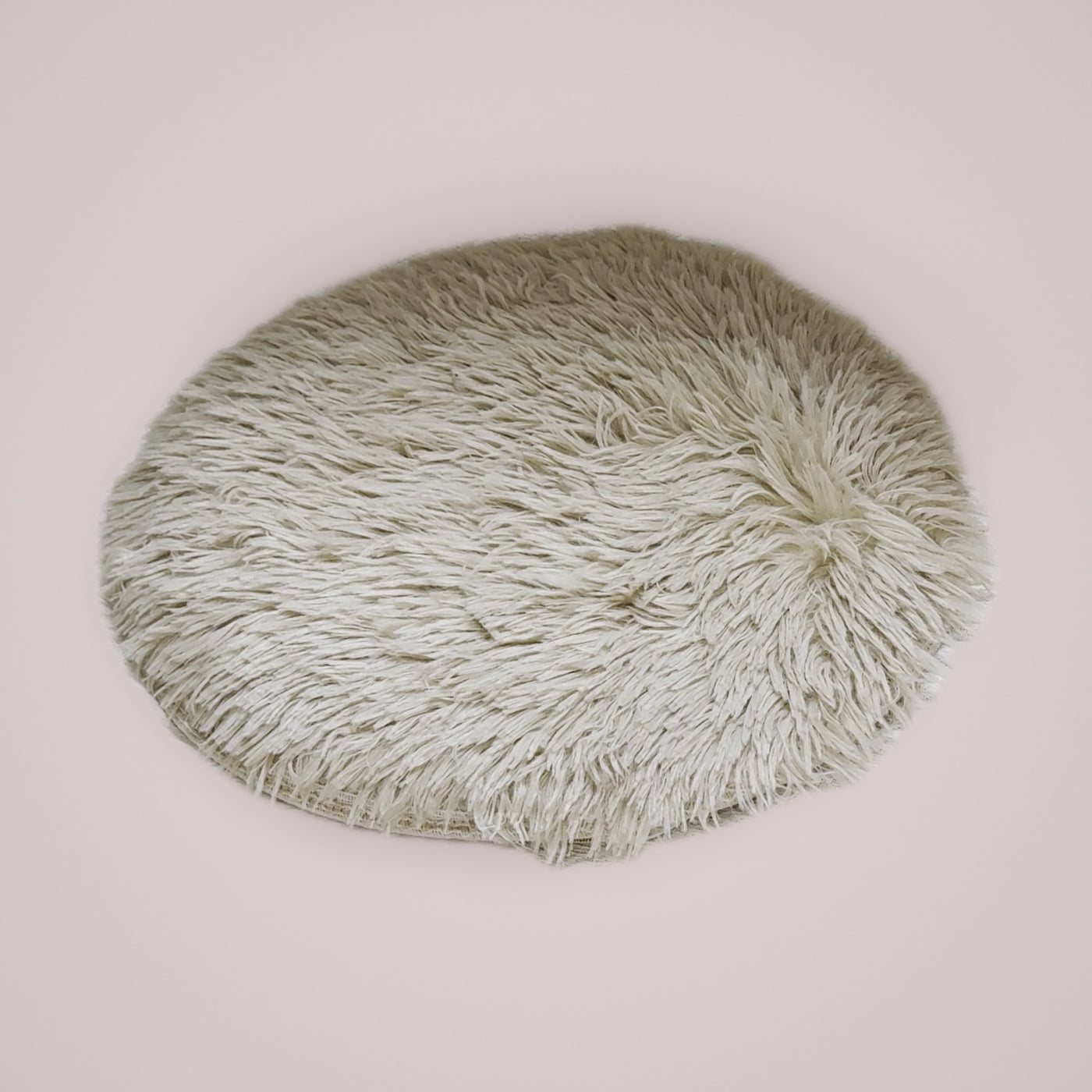 Holmere heated donut cat bed in oat — three-quarter angle showing the raised bolster