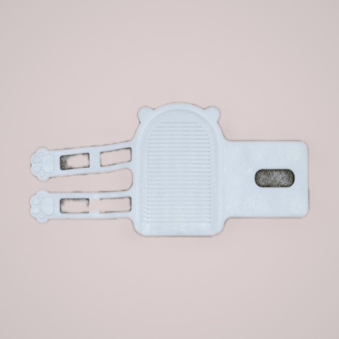 Holmere corner grooming comb — reverse, showing the ribbed back and strap layout