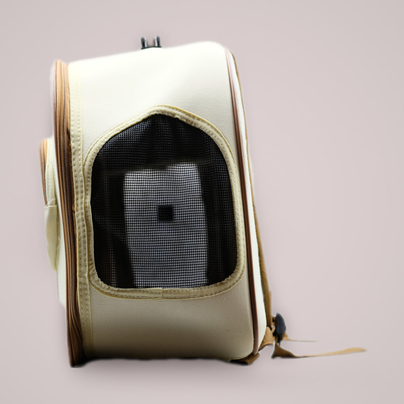 Holmere cat carrier backpack — side profile with mesh ventilation window